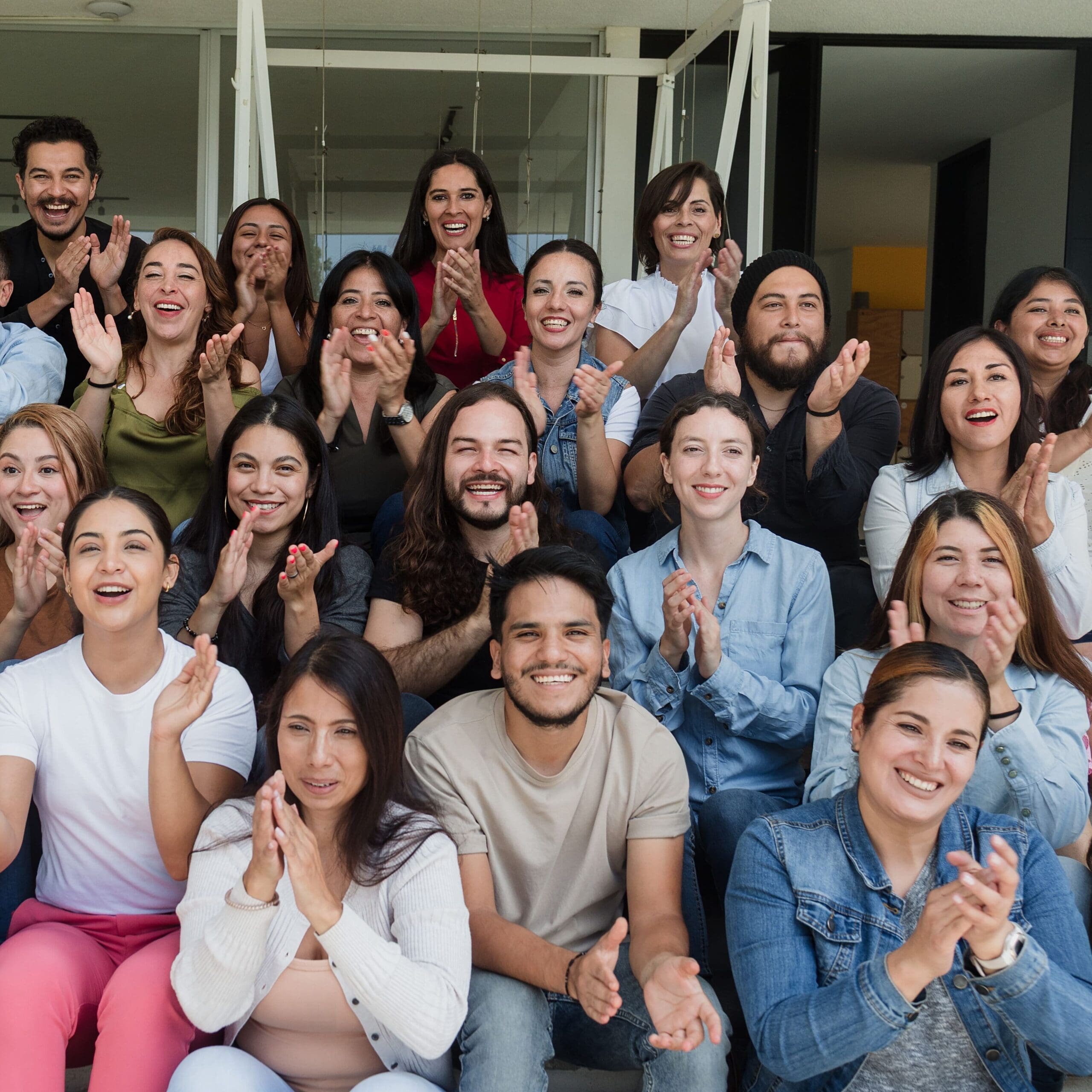 Diverse group of latin people applauding after successful conference in convention center